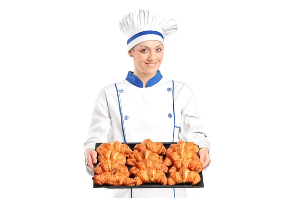 Female baker holding baked croissants — Stock Photo, Image