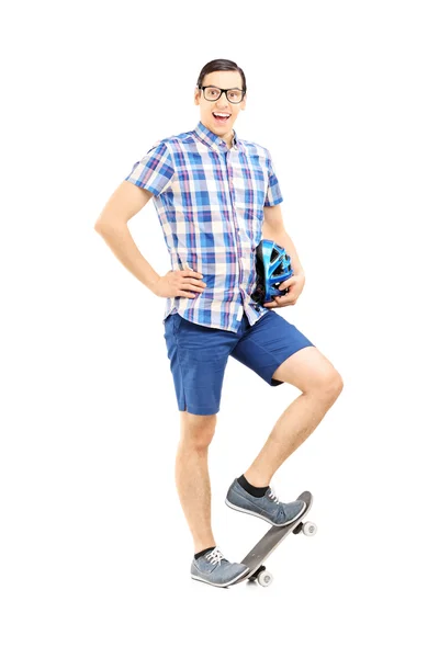 Guy holding helmet and skateboard — Stock Photo, Image