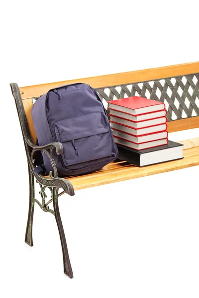 Bench with books and school bag — Stock Photo, Image