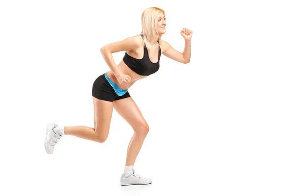 Una mujer atractiva corriendo — Foto de Stock