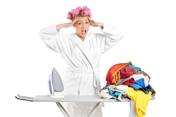 Annoyed housewife with ironing board — Stock Photo, Image