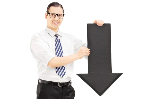 Hombre sosteniendo flecha negra apuntando hacia abajo —  Fotos de Stock