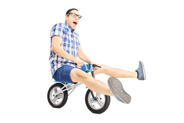 Nerdy male riding small bicycle — Stock Photo, Image