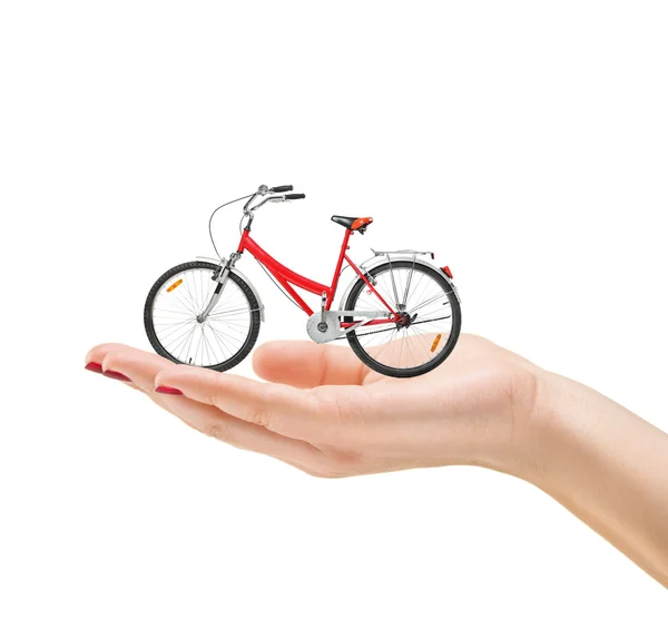 Vrouwelijke hand bedrijf fiets — Stockfoto