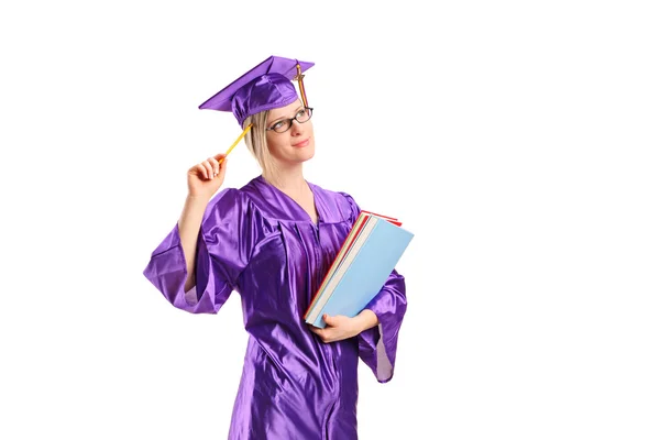 Graduado estudante segurando livros — Fotografia de Stock