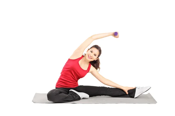 Female athlete exercising with dumbbell — Stock Photo, Image