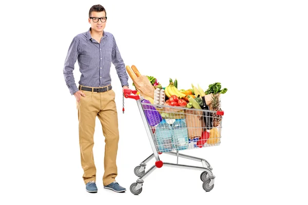 Male posing next to shopping cart — Stock Photo, Image
