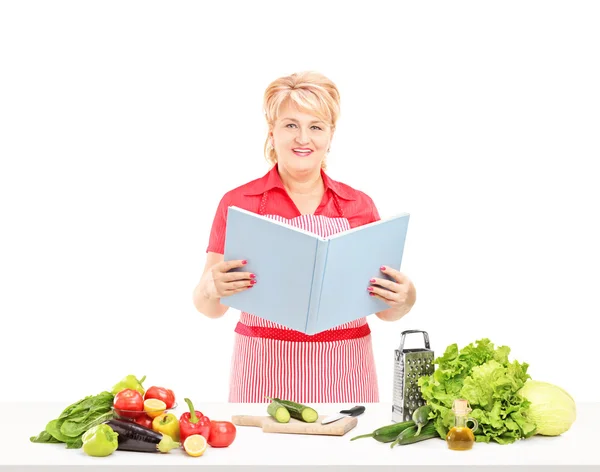 Cooker with book of recipes — Stock Photo, Image