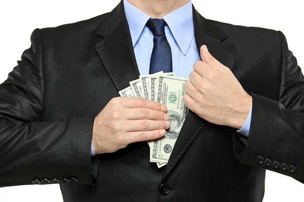 Businessman putting money in his pocket — Stock Photo, Image