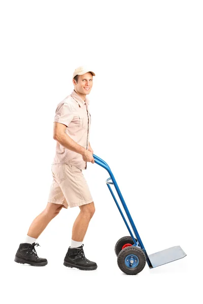 Manual worker pushing an empty handtruck — Stock Photo, Image