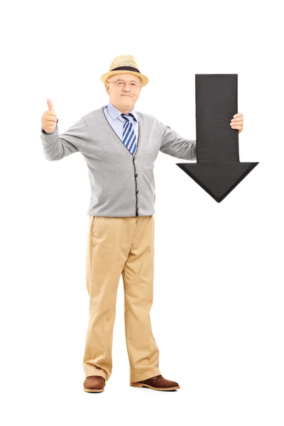 Man holding an arrow pointing down — Stock Photo, Image