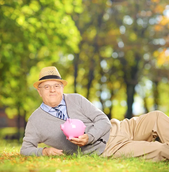 Gentleman holding piggy bank — Stock Photo, Image