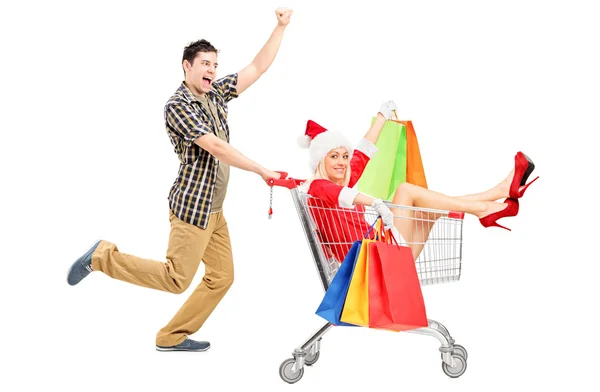 Male pushing woman in shopping cart — Stock Photo, Image