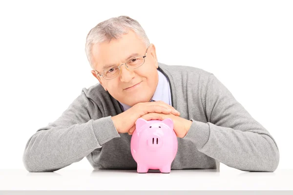 Mature gentleman over piggy bank — Stock Photo, Image