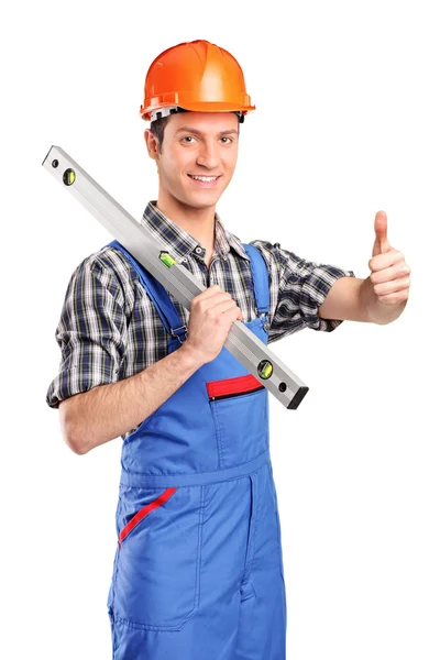 Worker holding construction bubble level — Stock Photo, Image