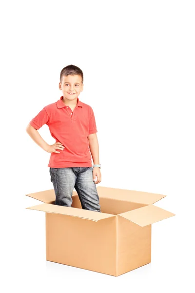 Little boy standing in carton box — Stock Photo, Image