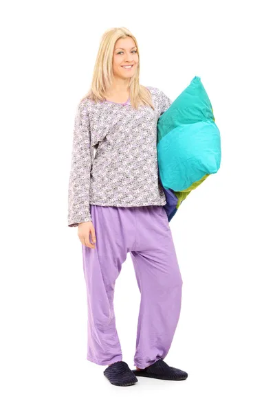 Blond girl in pajamas holding pillow — Stock Photo, Image