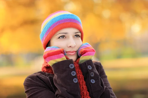 Beautiful young female with woolen cap and gloves in autumn — Stock Photo, Image