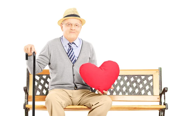 Senior man holding a red heart — Stock Photo, Image