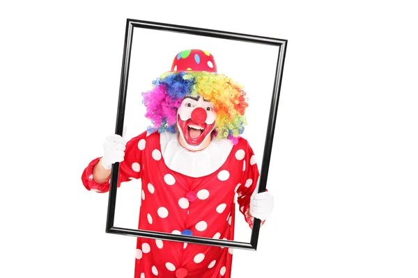 Clown håller bildram — Stockfoto