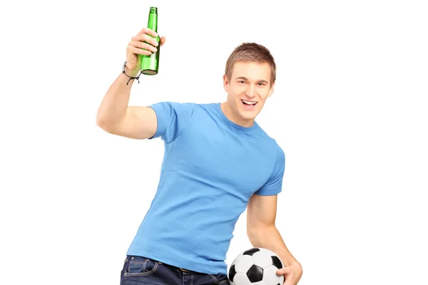 Fan holding beer and football — Stock Photo, Image