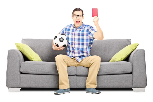 Furious football fan on sofa — Stock Photo, Image