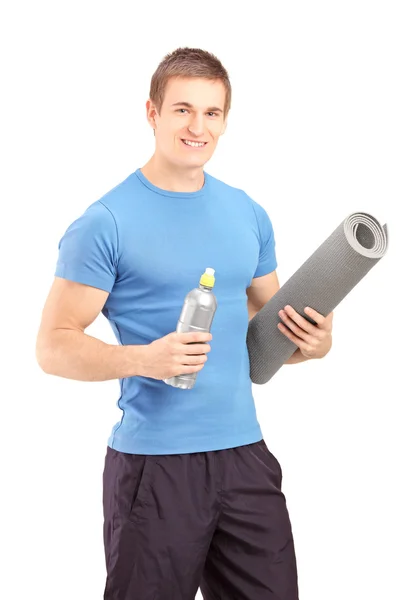 Male holding bottle and mat — Stock Photo, Image