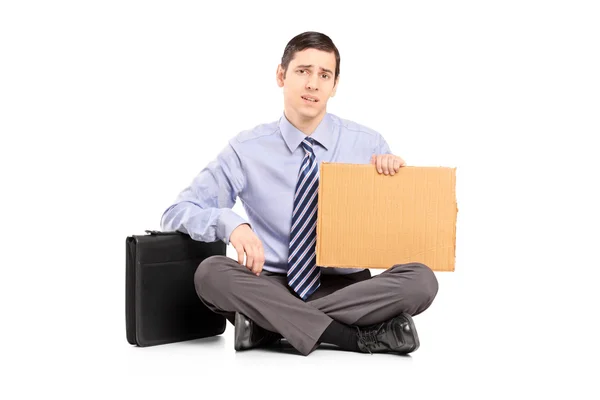 Businessman with piece of cardboard — Stock Photo, Image