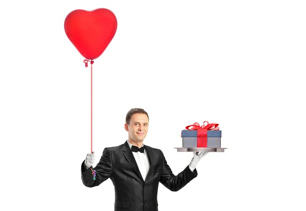 Waiter holding balloon and gift — Stock Photo, Image