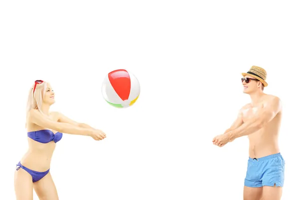 Male and female playing beach ball — Stock Photo, Image