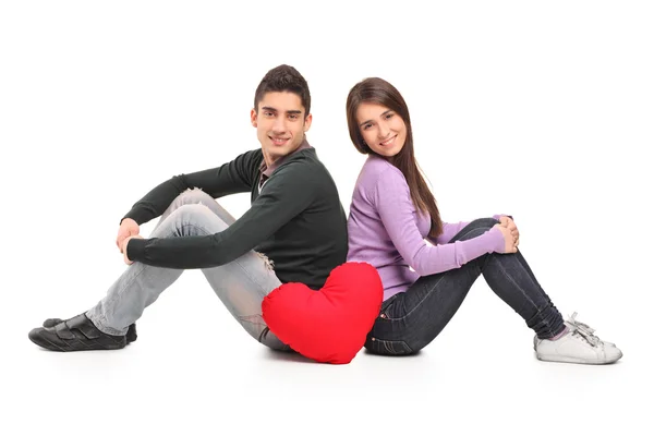 Couple and red heart shaped pillow — Stock Photo, Image