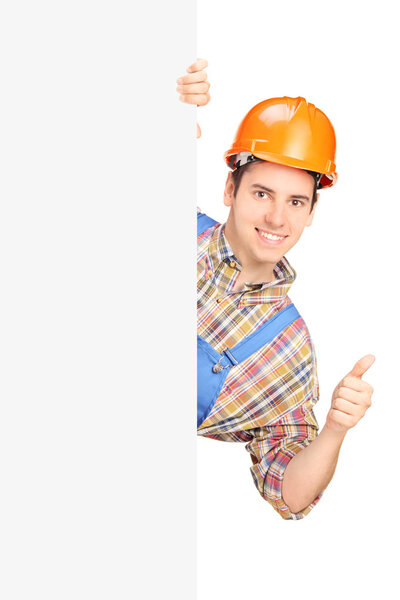 Construction worker behind a panel thumb up