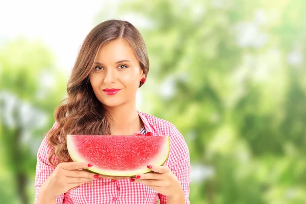 Smiling woman holding watermelon — Stock Photo, Image