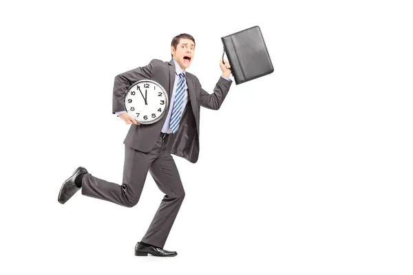 Businessperson running late with clock — Stock Photo, Image
