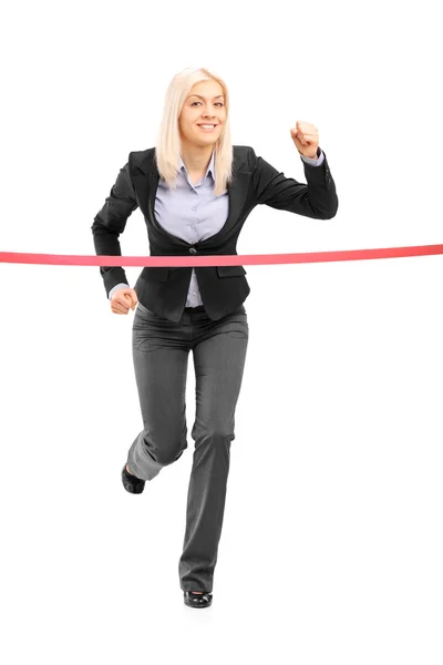 Businesswoman reaching finish line — Stock Photo, Image