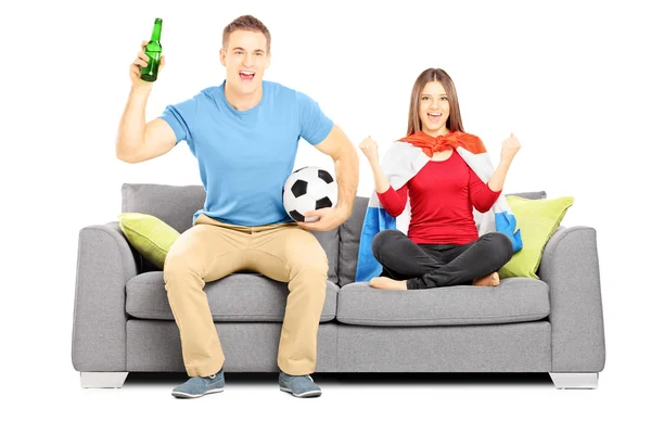 Female and male football supporters cheering — Stock Photo, Image