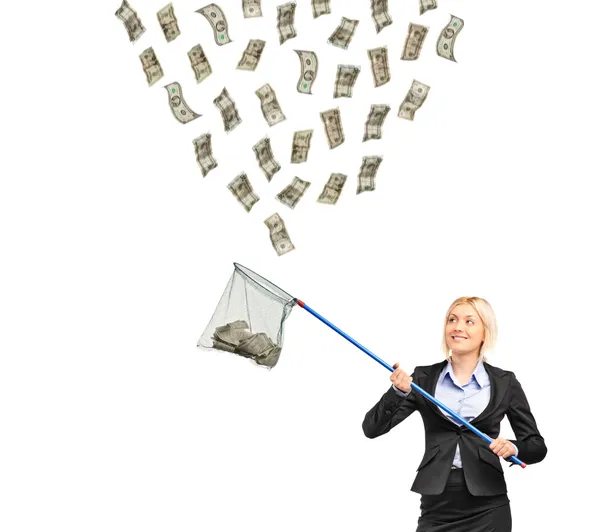 Businesswoman with a  net trying to catch money — Stock Photo, Image