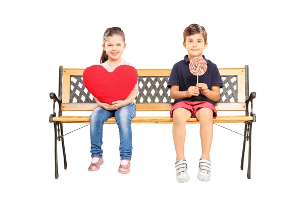 Kids holding heart and lollipop — Stock Photo, Image