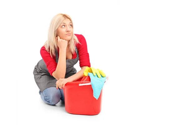 Female cleaner sitting next to bucket — Stock Photo, Image