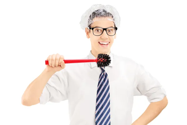 Man holding a toilet brush to clean his teeth — Stock Photo, Image