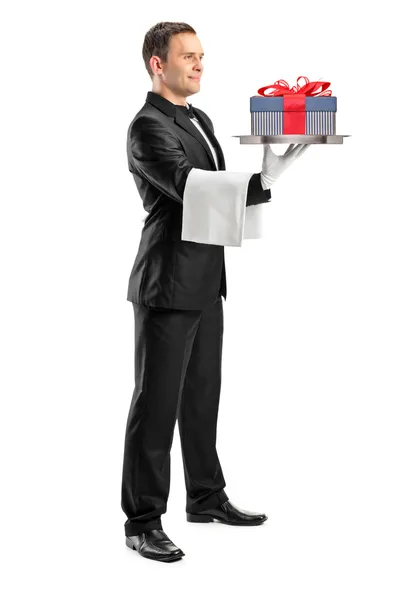 Butler carrying tray with gift — Stock Photo, Image