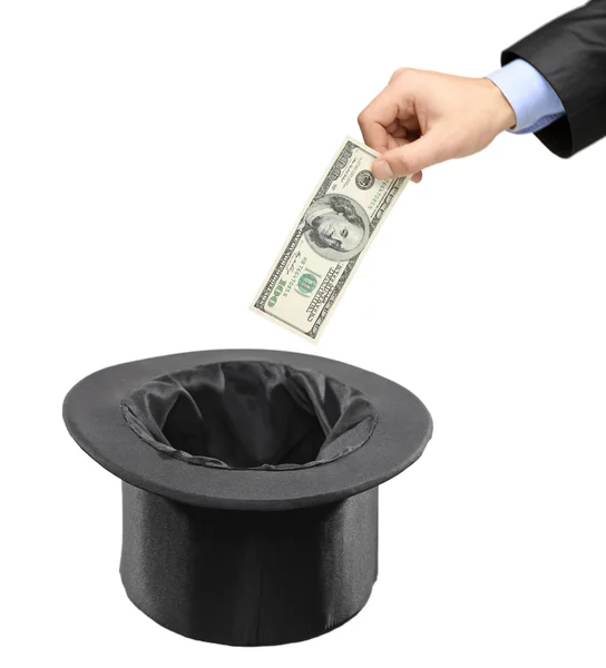 Man dollar invoegen in zwarte hoed — Stockfoto