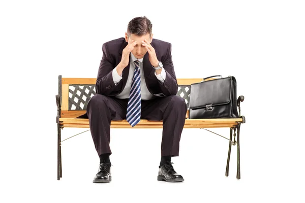Disappointed businessperson on bench Stock Picture