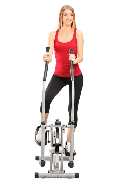 Athlete on cross trainer machine — Stock Photo, Image