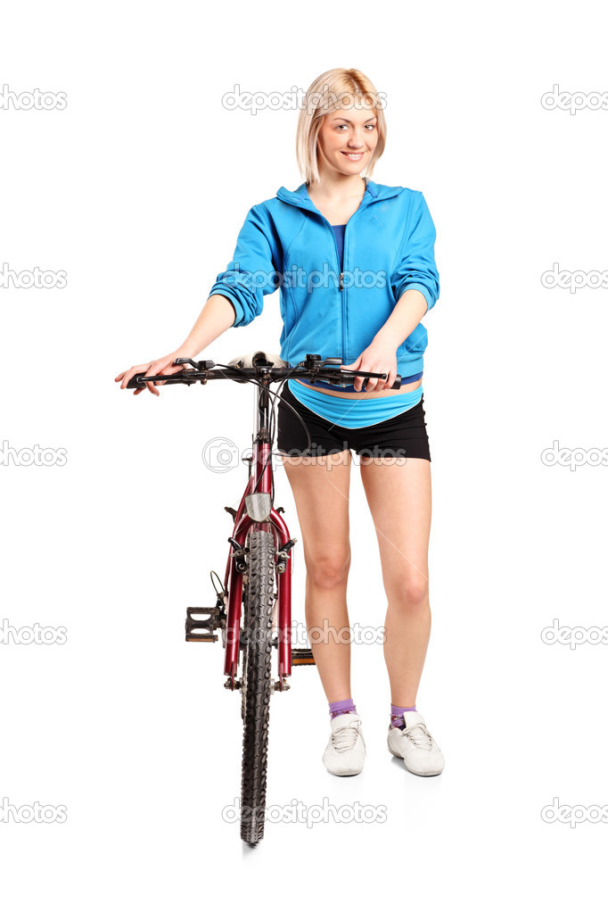 A blond female posing next to a bicycle