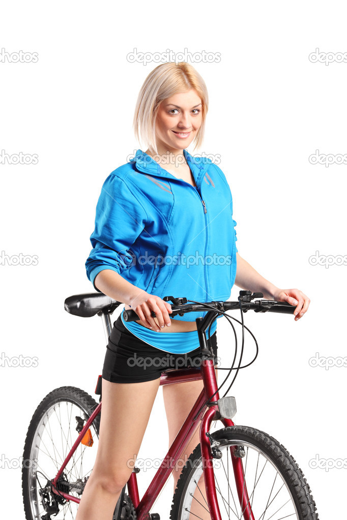 Beautiful smiling female posing next to a bicycle