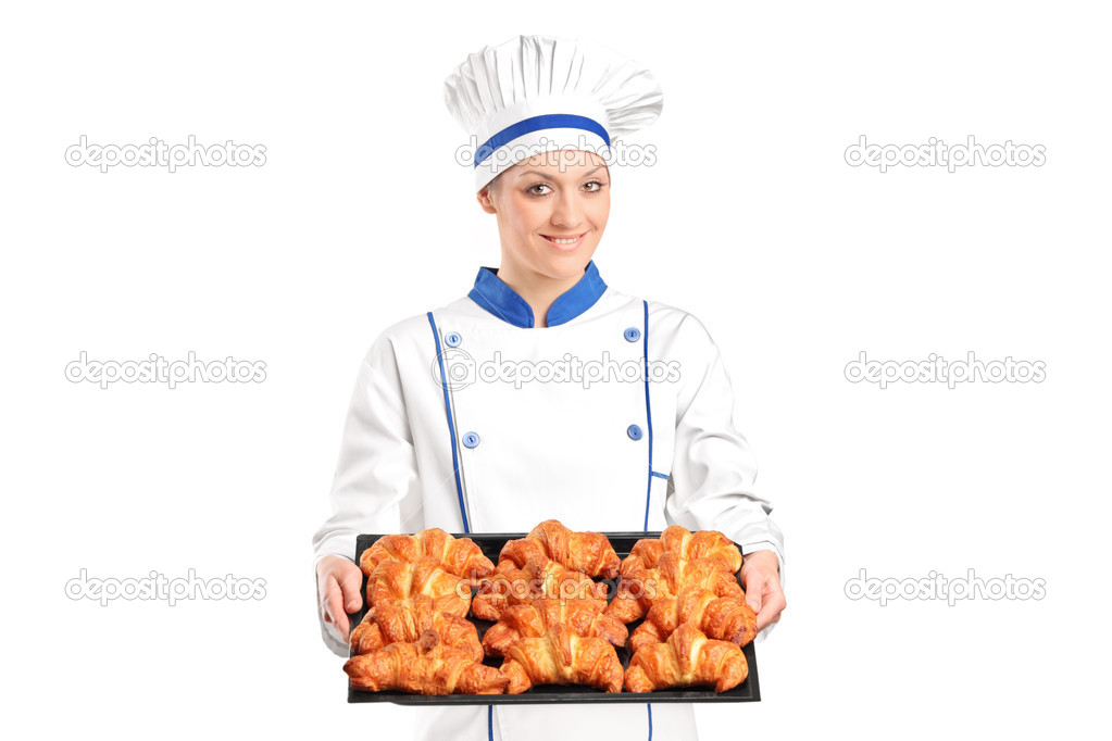 Female baker holding baked croissants