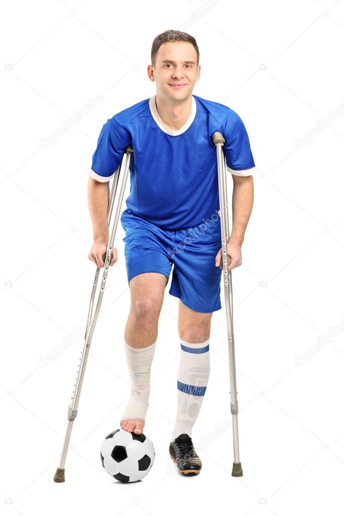 Injured football player on crutches