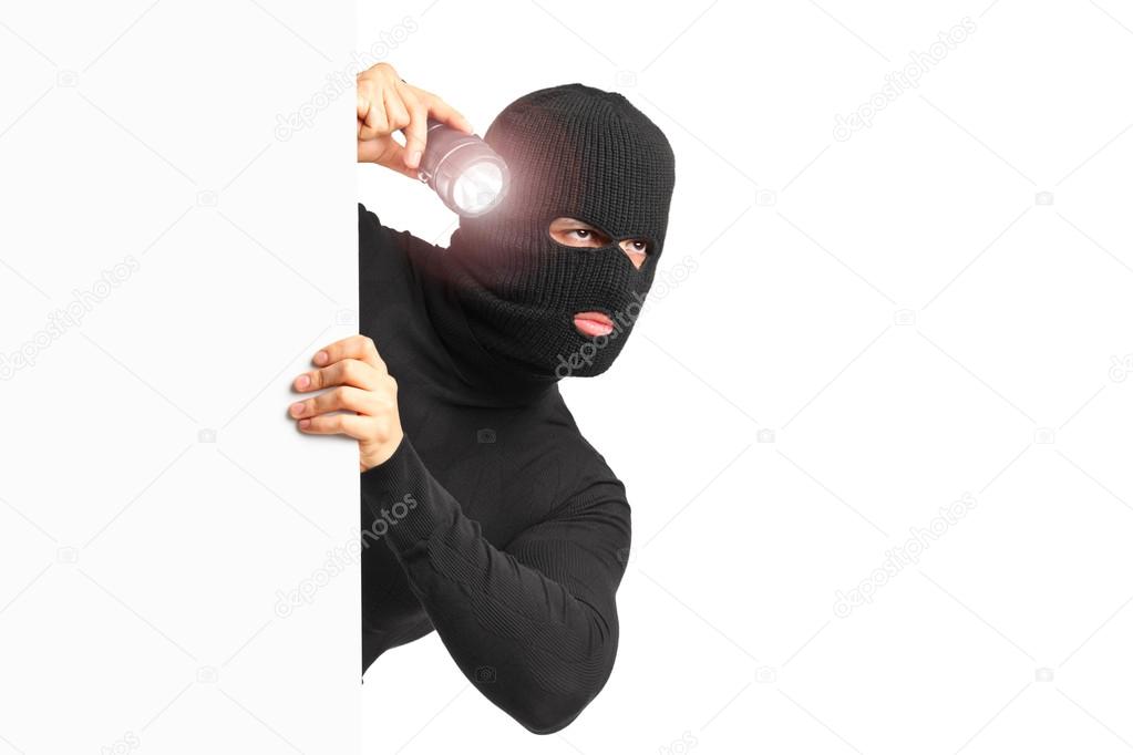 Thief holding flashlight