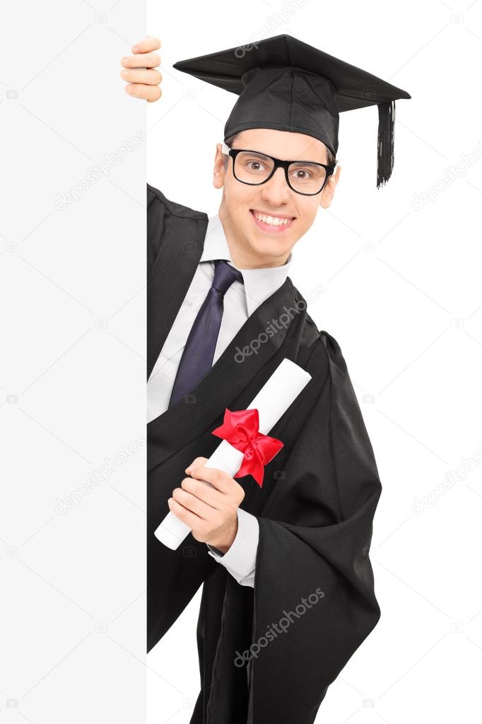 Young male student holding diploma